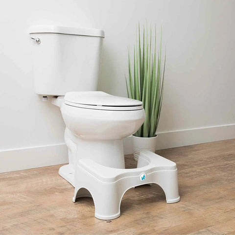 Toilet Stool 2.0 Base 7 Inch White for Natural Elimination, positioned in front of a standard toilet in a bathroom setting