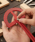 Heavy Duty Angle Finder With Dead Nuts Secure Locking Swing Arm Reads Zero To One Eighty Degrees For No Sweat Transfer On Baseboard Trim Or Workshop Setup in use, adjusting angle with metal knob.