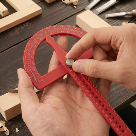 Heavy Duty Angle Finder With Dead Nuts Secure Locking Swing Arm Reads Zero To One Eighty Degrees For No Sweat Transfer On Baseboard Trim Or Workshop Setup in use, adjusting angle with metal knob.