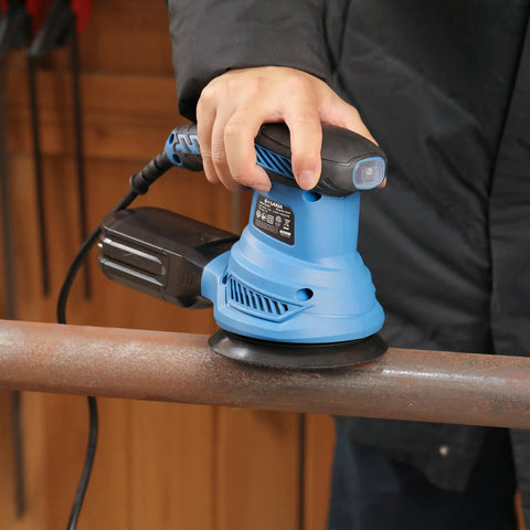 Beefy 4.9 Inch Random Orbital Sander Corded Power Tool With Full 20 Piece Sandpaper Roll Kit in use on a metal surface.