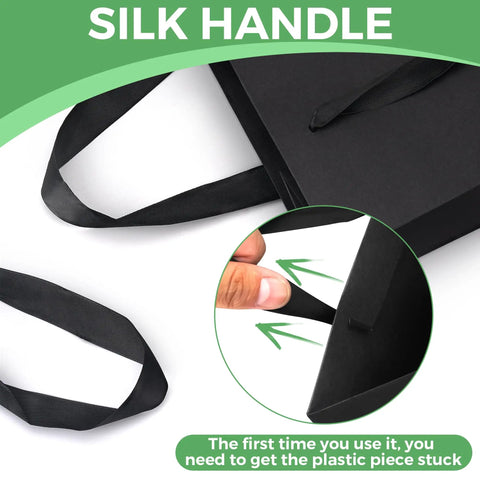 Close-up of silk handles on extra large black gift bags with instruction for use; Extra Large Black Gift Bags With Handles 16 By 6 By 12 Inches 3 Pack Bulk Paper Bags For Party Shopping Birthday Wedding Gift Wrapping And Home Decor For Everyday Use.