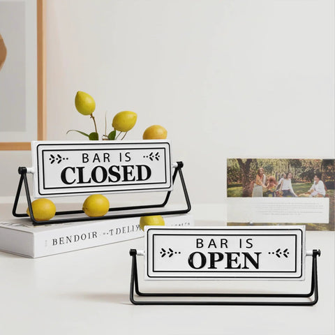 Smooth Flipping Open Closed Sign, Handmade Metal Counter Decor For Your Cozy Home Bar Or Office Coffee Spot With Black Stand And Embossed Lettering. Bar is Open and Bar is Closed signs displayed.