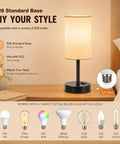 Set Of 2 Bedside Table Lamps For Bedroom And Living Room With 3 Way Dimmable Rocker Switch And Built In AC Outlet Flaxen Fabric Shade Black Base Nightstand And Desk Lamp For Cozy Home Decor showcasing E26 bulb compatibility and black base on a wooden table.