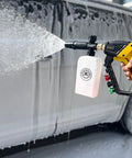 Adjustable Length High Power Washer Gun 5000 PSI With Foam Cannon And Quick-Change Nozzles spraying foam on car for cleaning