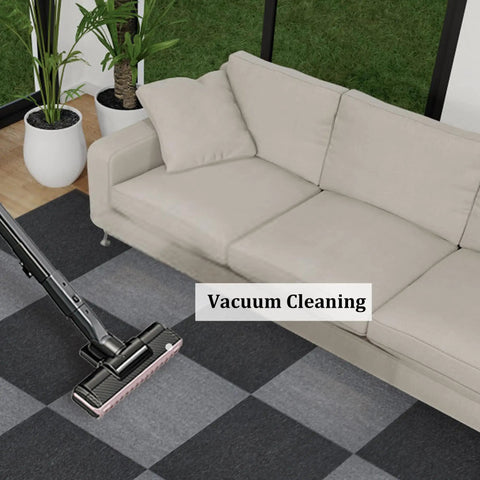 DIY 20x20 Carpet Tile Set With Self Adhesive Strips, Dual Color Light and Dark Gray, 0.16 Inch Pile being vacuumed near sofa