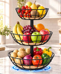Three Tier Rotating Fruit Basket For Kitchen Counter, Easy Spin Metal Storage Rack With Natural Bamboo Base, Heavy Duty Produce Holder filled with fresh fruits and vegetables.