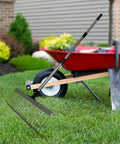 Rugged Heavy Duty Lawn Rake With Splicing Handle And 21 Tine Design For Effortless Debris Cleanup Leaves Thatch And Grass Clippings Ergonomic Rake 40 Cm Wide And 125 Cm Extendable Three Section next to wheelbarrow on lawn