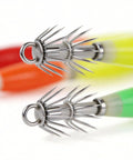 Close-up of Night Fishing Glow In The Dark Squid Jigs Kit 10 Pcs showing fluorescent hooks in red, orange, yellow, green
