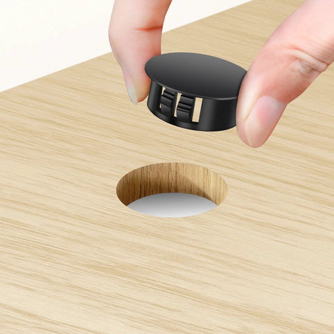 Plastic hole plug being inserted into wood surface from 200 Piece Plastic Hole Plug Set with 9 sizes for cabinets and furniture