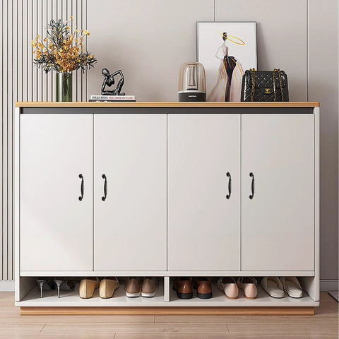 Front view of white cabinet with matte black aluminum alloy handles, showcasing a stylish decor with flower vase and art print