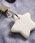 Star-shaped marble weight with stainless clip from 10 Pack Marble Tablecloth Weights With Clips on fabric background.