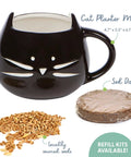 Organic Cat Grass Growing Kit For Indoor Cats With Premium Seed Mix, Soil, And Planter, Hairball Control And Digestion Support, No Fuss Grow Instructions Cruelty Free Gift For Cat Lovers showing black cat-shaped mug, seeds, and soil disk