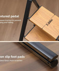 Three Step Ladder With Anti Slip Pedals, Folding Step Stool In Black And Woodgrain, close-up of textured pedal and non-slip foot pad
