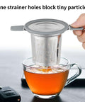 Stainless Steel Loose Leaf Tea Infuser With Extra Fine Mesh Ball Heat Proof Dual Handle Steeper for Mugs over glass cup.