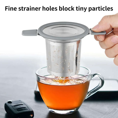 Stainless Steel Loose Leaf Tea Infuser With Extra Fine Mesh Ball Heat Proof Dual Handle Steeper for Mugs over glass cup.