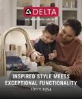 Mother and child using kitchen faucet in cozy kitchen setting with Delta logo above, showcasing brand message and functionality.