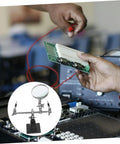Hands using Adjustable Third Hand Soldering Station With Magnifying Glass And Dual Alligator Clips for PCB repair in electronics