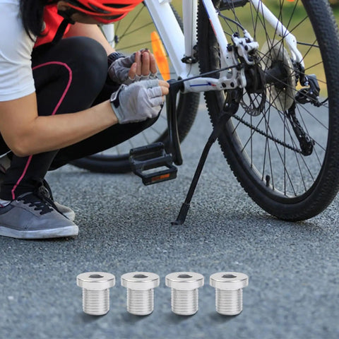 Cyclist installing Rear Derailleur Hanger Bolts M10xP1.0 Thread, 13.8mm Length into a bike, shown with silver bolts, 4 pack