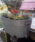 Galvanized metal tub planter with flowers mounted outdoors on a wooden post using heavy duty 16 inch shelf brackets with lip tough industrial wall mount metal storage brackets for indoor outdoor use rust resistant includes screws 2 pack black.