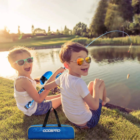 Two kids fishing by a pond with the Kids Fishing Pole Starter Kit With Tackle Box, Reel, Practice Plug and Travel Bag, enjoying outdoors.