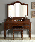 Antique vanity dresser with mirror featuring brass cabinet pulls and leather stool, classic wooden design with vintage accents.