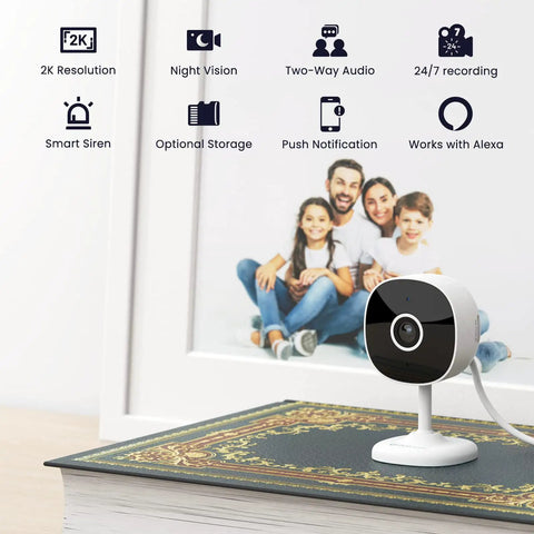 Indoor Home Security Camera 2K With Two Way Audio on a table, family photo backdrop, icons highlighting features like night vision and smart siren.
