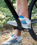 Cyclist wearing 2 Pack Bike Pedal Straps Toe Clips Straps Adjustable Anti Slip Cycling Foot Straps for kids and adults.