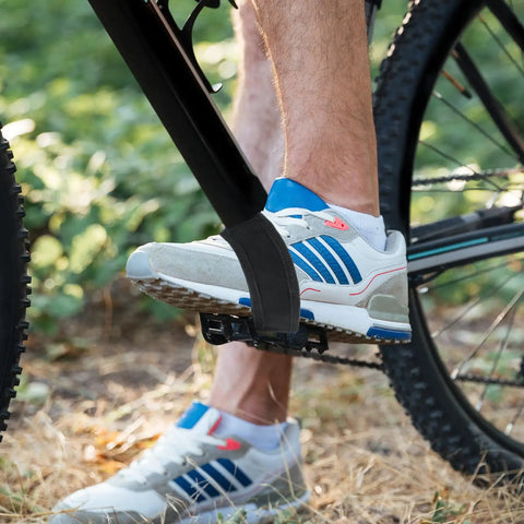 Cyclist wearing 2 Pack Bike Pedal Straps Toe Clips Straps Adjustable Anti Slip Cycling Foot Straps for kids and adults.