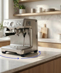 Silver coffee maker on a marble countertop with Self Adhesive Mini Caster Wheels For Appliances 8 Pack attached underneath.