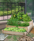 Three Tier Raised Garden Bed With 47 Inch Square Footprint And 22 Inch Height Wooden Planter in backyard, filled with plants.