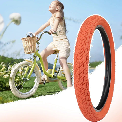Orange 20x2.35 Bike Tire Set For BMX MTB next to a girl on a bicycle in a sunny field