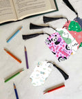 Five Set Of Thirty Six Bookmark Die Cuts And Tag Dies With Embossing Stencils For Scrapbooking with colored pencils on table