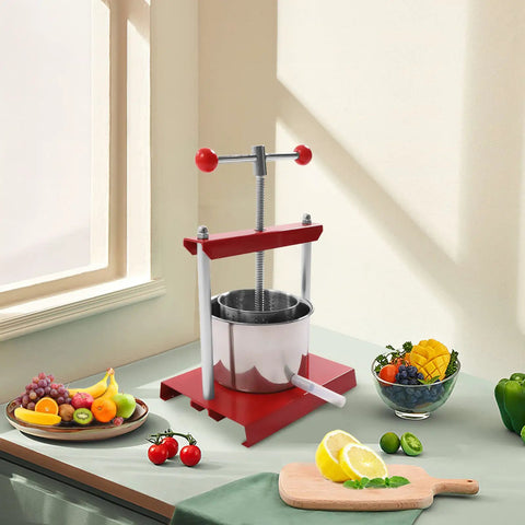 Heavy Duty Manual Fruit Wine Press Built Like A Tank Food Grade Stainless Steel Apple Grape Juicer on kitchen counter with fruits.