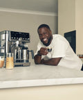 Brew Like A Pro At Home With This Triple Threat Espresso And Drip Coffee Maker Featuring Rapid Cold Brew Options Alongside Reliable Dual Shot Settings In Sleek Gunmetal Finish, sleek kitchen setup with drinks.