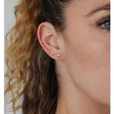Hypoallergenic Sterling Silver Round Ball Stud Earrings Set For Women And Men With Butterfly Backs Three Pairs In 2mm 3mm And 4mm Sizes Lightweight Minimalist Everyday Jewelry worn in multiple ear piercings