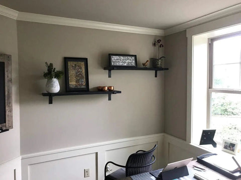 Wall with two floating shelves supported by Built Tough 5.5 Inch Black Shelf Brackets With Lip For Floating Shelves, rustic style