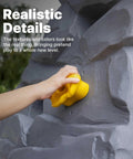 Hand gripping a yellow hold on the Skyward Summit Climbing Wall Playset For Kids Ages Four To Eight, realistic rock textures