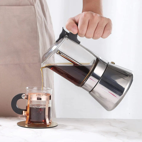 Pouring coffee from Induction Friendly Moka Pot With Crystal Glass Top And Stainless Steel Stovetop Espresso Maker Pro Level Brew Classic Italian Coffee Brewer 160ml Transparent Glass Body For Easy Brew Control Durable And Easy To Clean into cup