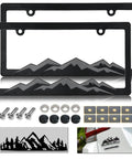 Mountain License Plate Frame Set For Cars And Trucks With Dope 3D Raised Mountain Design Plastic Tag Holder In Gray On Black Finish 2 Pack With 2-Hole Mounting Screws And Caps Includes Mountain Vinyl Sticker with all components shown.