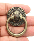 Close-up of Vintage Antique Brass Ring Pull Handle with round disk shield, zinc alloy, showing rust resistant hardware