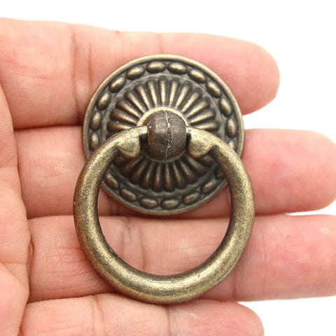 Close-up of Vintage Antique Brass Ring Pull Handle with round disk shield, zinc alloy, showing rust resistant hardware