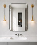 XYDikssn Gold Wall Sconce, Hardwired Wall Light with Brushed Brass and Clear Ribbed Glass Shade, modern bathroom sink setup.