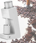 Top Shelf Electric Conical Burr Coffee Grinder With Stepless Dial For No Sweat Espresso Easy Pour Over And French Press Plus Chill Quiet Motor And Quick Wipe Brush In Bold White, detailed view with coffee beans in background.