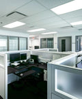 Modern office interior with cubicles, illuminated by ceiling lights using 24 Inch T8 Fluorescent Tube Light Bulb 17W 5000K Bright White.