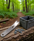 Mini Stainless Steel Pocket Pry Bar Crowbar Multifunction EDC Tool For Bushcraft And Survival on a log with screws and box in forest