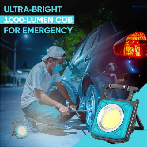 Go-To Mini COB Flashlight Keychain 1000 Lumens With 4 Modes shown illuminating a tire repair at night