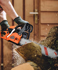 Beast 62cc Gas Powered Chainsaw With 20 Inch Bar For Tree Cutting And Firewood cutting through a log outdoors