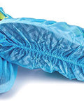 Slip Resistant Disposable Boot And Shoe Covers Blue Large 50 Pairs Pack Pro Grade Heavy Duty Non Woven 35G Easy Slip On Fits Up To Men Size 11 And Women Size 13 showing elastic fit and texture.