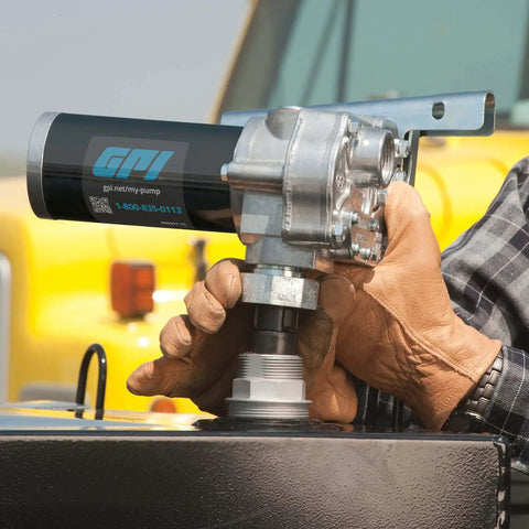 M-1115S-PO Fuel Transfer Pump For Stationary Tanks, 12 GPM At 115V, Built Tough For Gasoline Blends Up To E15, Diesel Up To B20, And Kerosene, Includes Spin Collar And Lockable Nozzle Holder For Quick, Safe Refills. Handheld pump mounted on a tank.