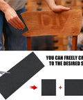 Person using Heavy Duty Silicon Carbide Sanding Sheets In 120 150 180 And 240 Grit Sizes Wet Or Dry on a wooden chair.